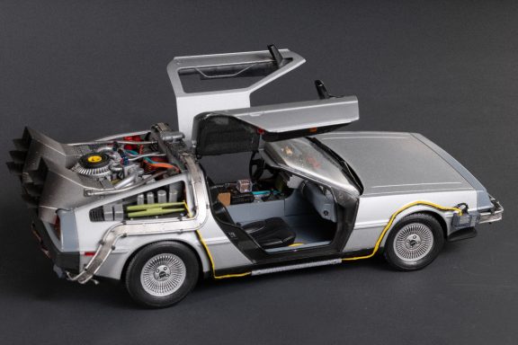 A silver DeLorean car model with gullwing doors and detailed interior features.